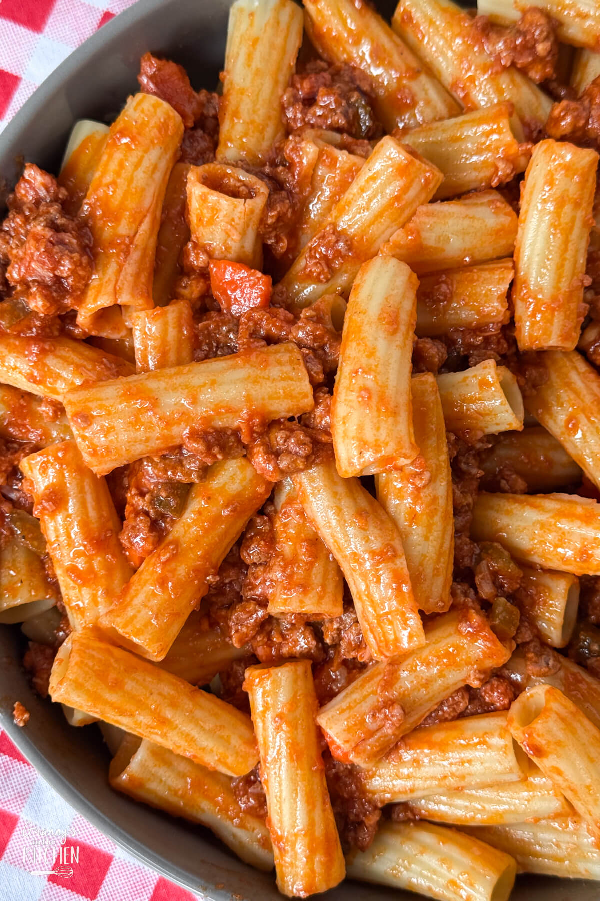 bowl of rigatoni tossed with meat sauce.