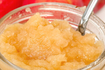 close up of a jar of applesauce, text overlay "Homemade Applesauce."