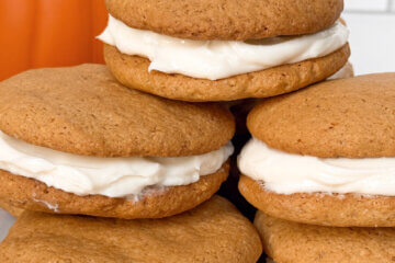 Pumpkin Whoopie Pies on plate with text overlay of recipe name.