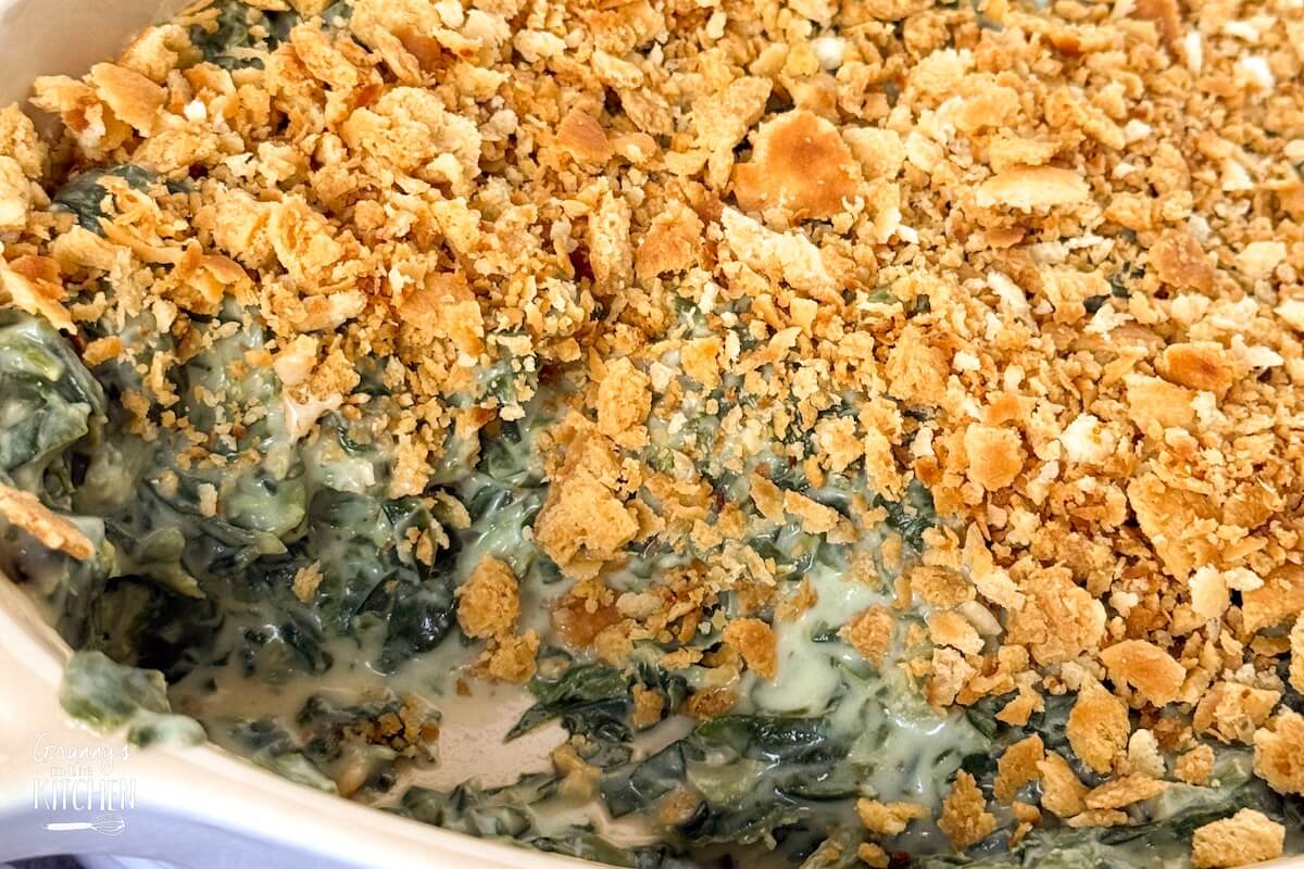 close up of a creamy spinach side dish topped with crispy breadcrumbs.