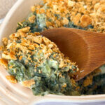 scooping a serving of Spinach Madeline casserole out of the dish.