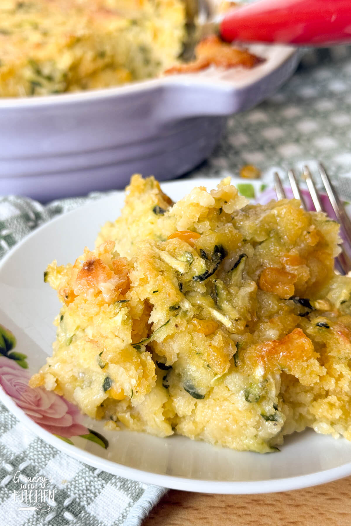 close up of a serving of zucchini casserole on a plate.