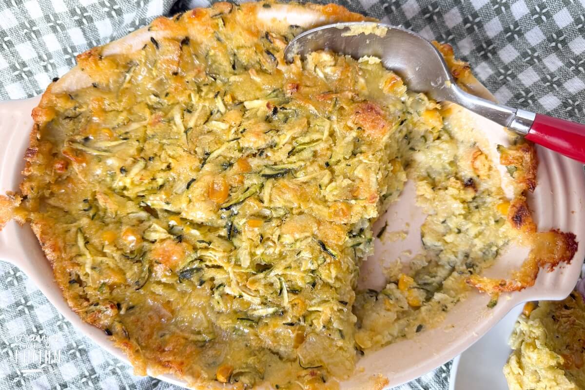 top down view of a zucchini casserole, with a serving spoon.