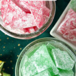 two mason jars of red and green candy, with text overlay "Hard Tack Candy"