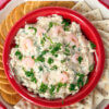 Creamy Shrimp Dip in a red bowl with crackers.