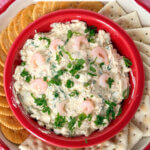 Creamy Shrimp Dip in a red bowl with crackers.