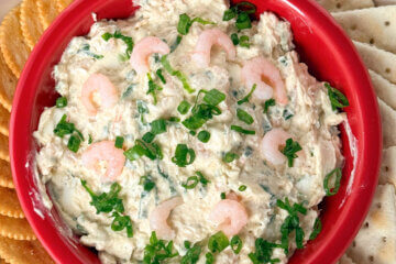 Creamy Shrimp Dip in a red bowl with crackers.