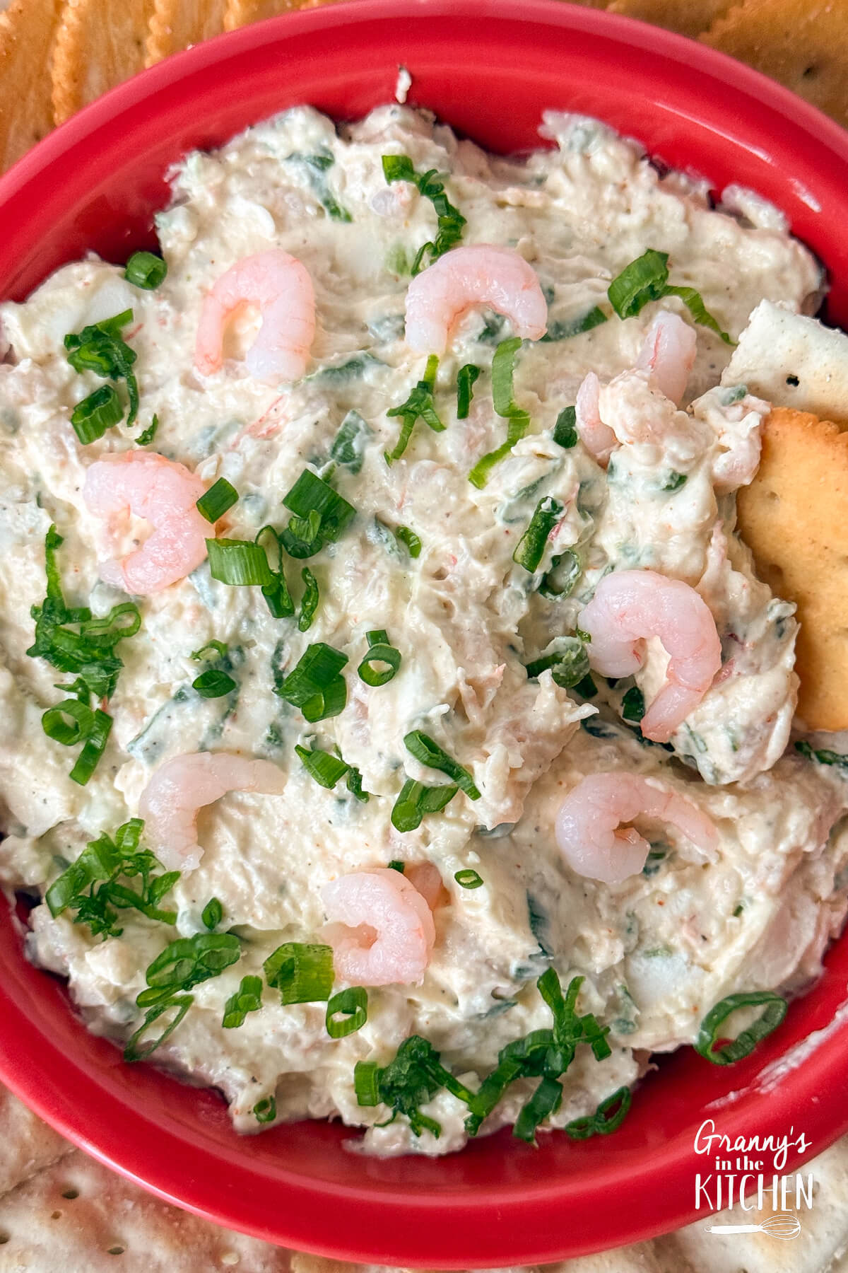 Crackers being dipped into Shrimp Dip.