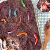 Dirt cake in a glass serving dish with one scoop taken out.
