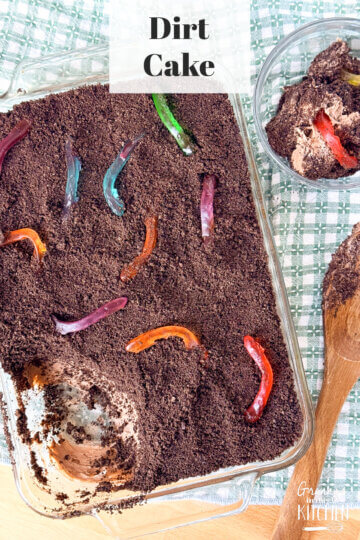 Dirt cake in a glass serving dish with one scoop taken out.