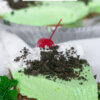 Slice of mint green pie with full pie in background; text overlay "Grasshopper Pie."