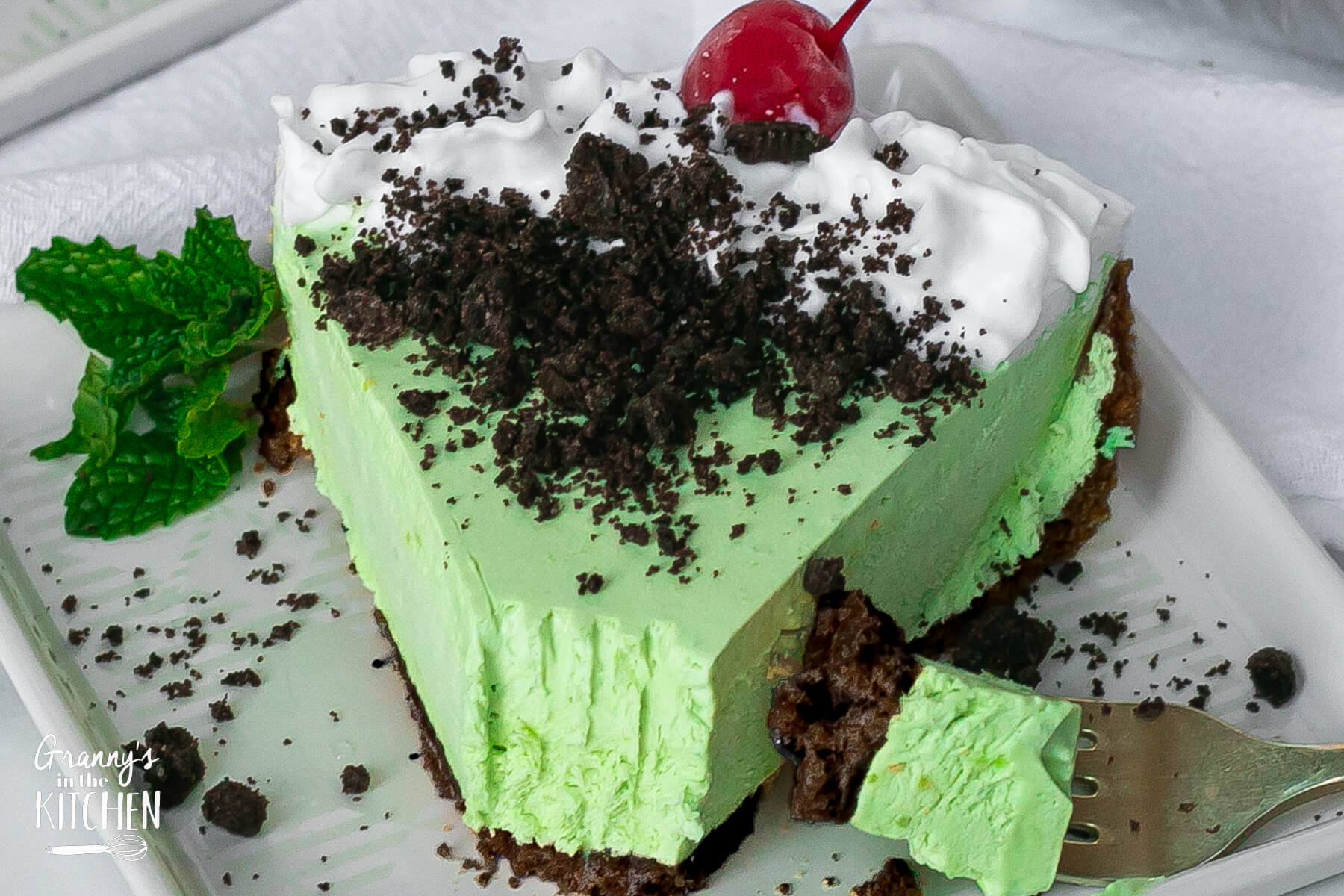 close up on a slice of Grasshopper pie, with a bite taken.