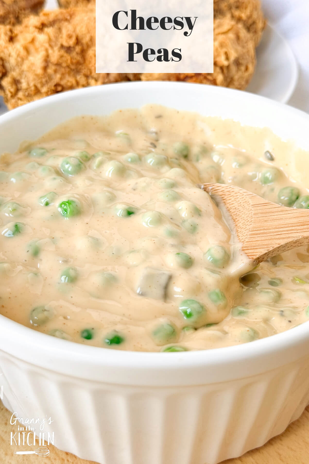 a bowl of peas in a thick and creamy cheese sauce; text overlay "Cheesy Peas."