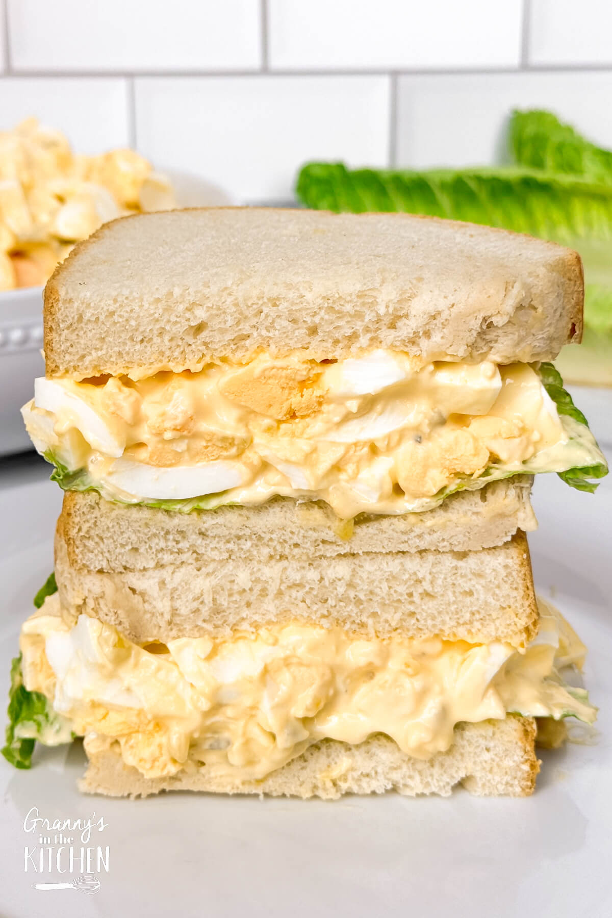 an egg salad sandwich, cut in half and stacked.