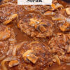 skillet with homemade hamburger steak and gravy; text overlay "Classic Salisbury Steak"