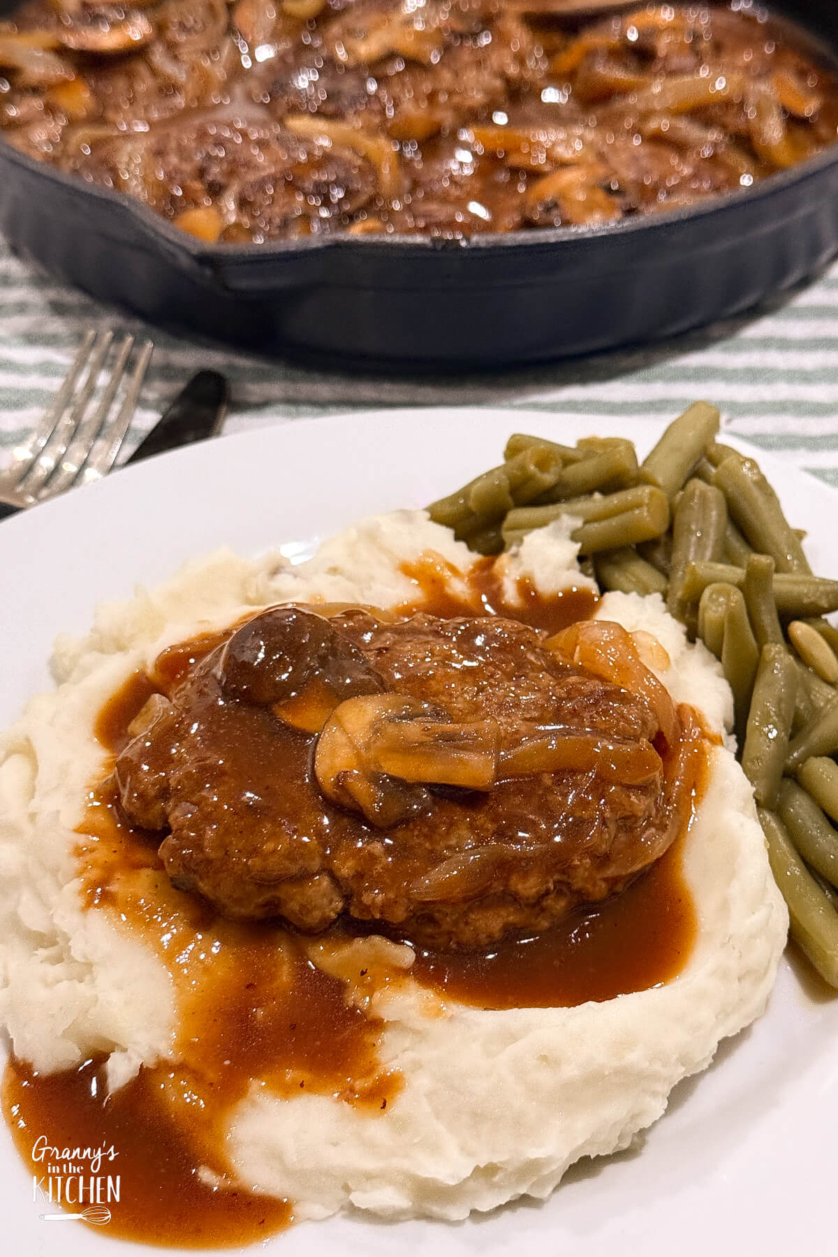 hamburger steak served on top of mashed potatoes.