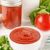 A white dish of Homemade Ketchup with a text overlay that says Homemade Ketchup.
