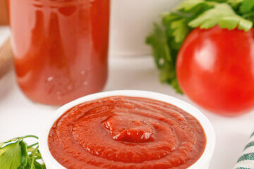 A white dish of Homemade Ketchup with a text overlay that says Homemade Ketchup.