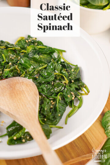 A white plate of Sautéed Spinach with a text overlay that says Classic Sautéed Spinach.