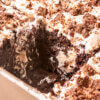 Toffee Poke Cake with a slice cut out of it.