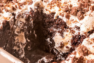 Toffee Poke Cake with a slice cut out of it.