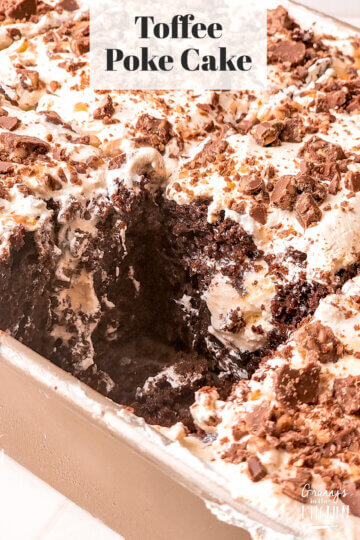 Toffee Poke Cake with a slice cut out of it.