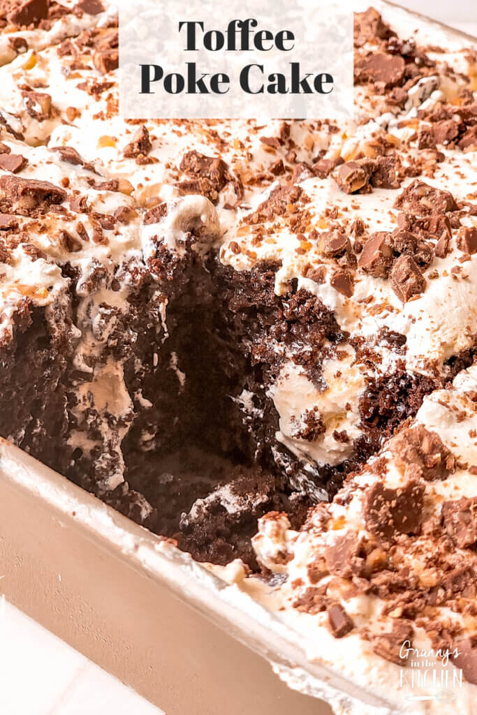 Toffee Poke Cake with a slice cut out of it.