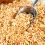 Homemade Italian Bread Crumbs with a metal scoop in it.